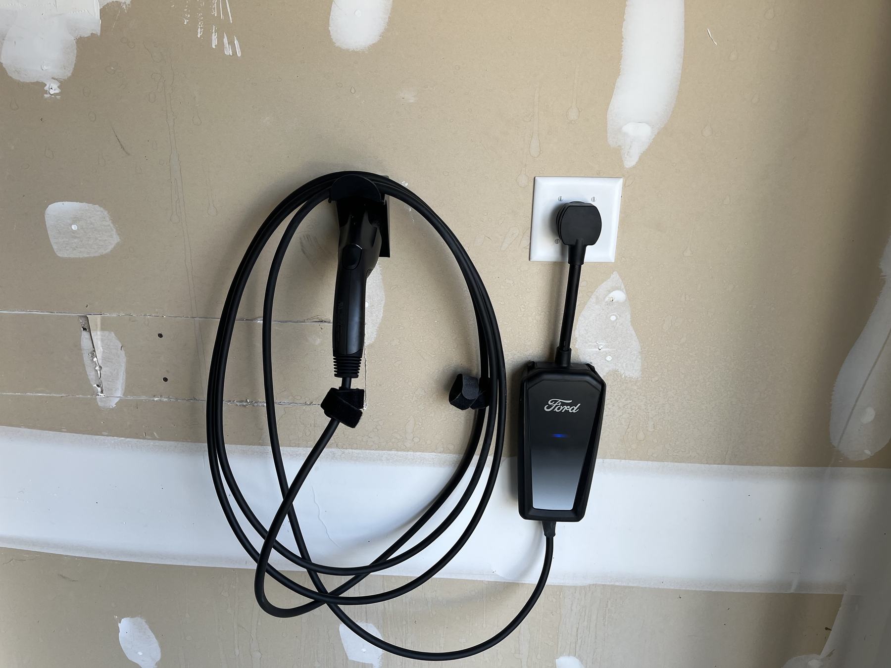 Wall-mounted EV charger in a garage