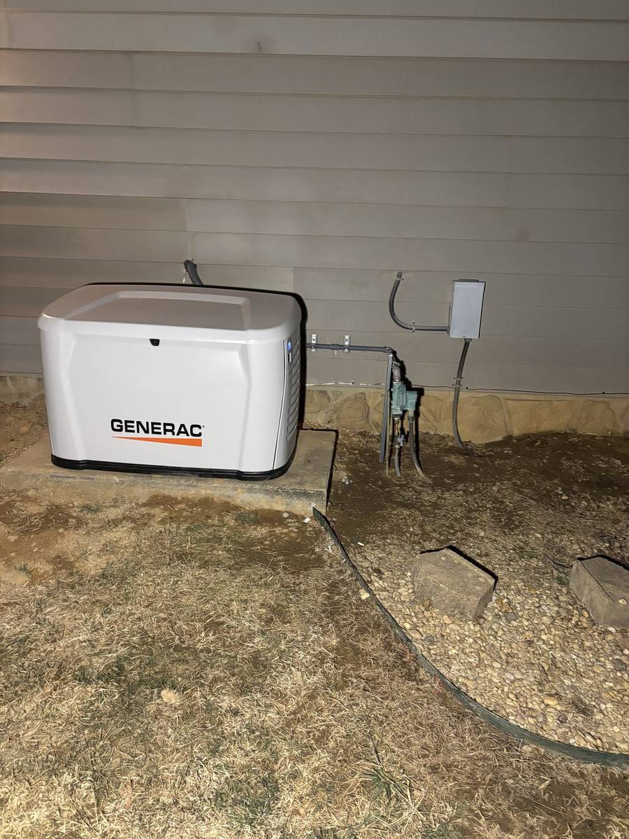 Generac standby generator newly set on its pad beside a home
