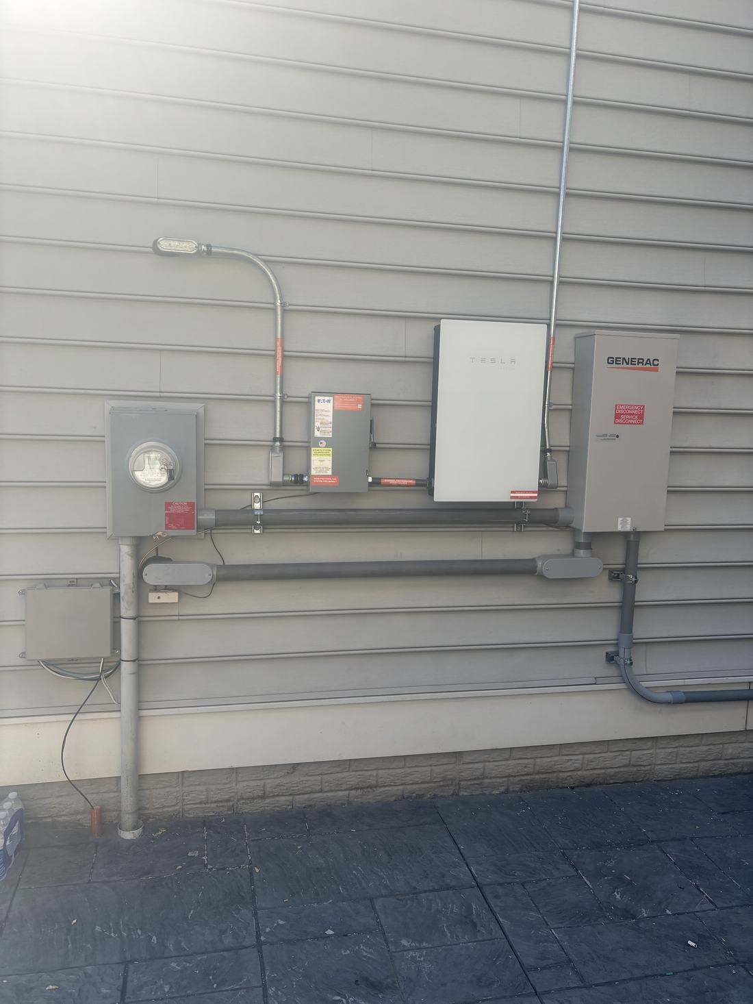 Meter, disconnect and panels on the side of a house