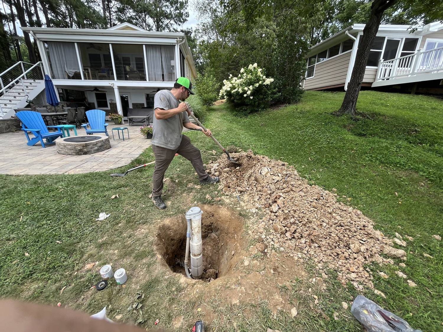 RJ technician digging to reach a sewer line in a back yard
